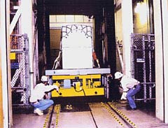 loading a palette of waste containers onto the waist hoist